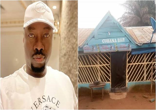 Obi Cubana reacts as he spots a small bar built with planks in his name.