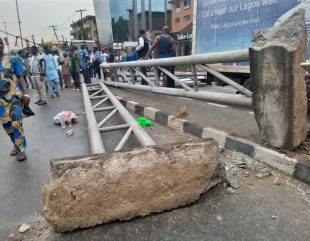 Man Escapes Death As Huge Billboard Falls On Keke Napep In Lagos (Video)