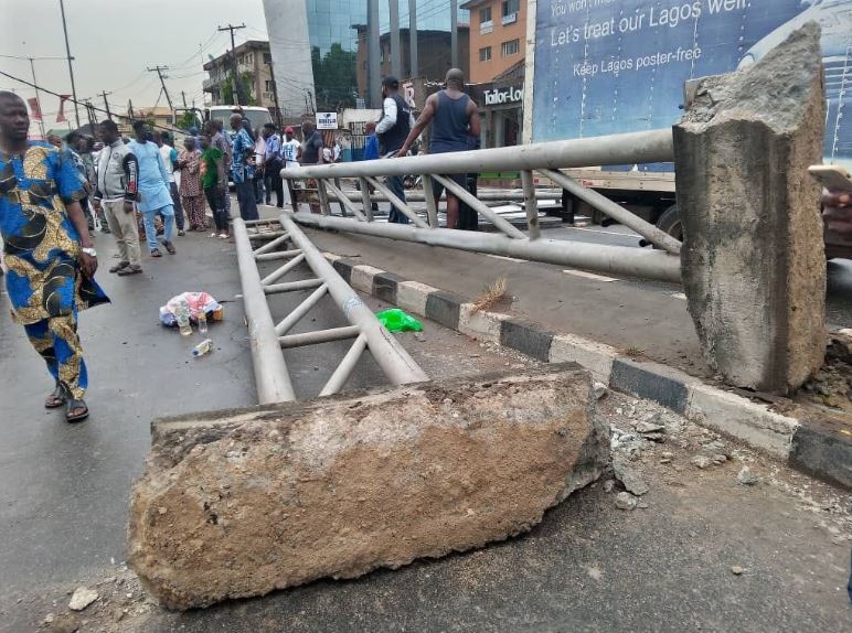 Man Escapes Death As Huge Billboard Falls On Keke Napep In Lagos (Video)