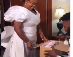 Bride gives her groom a box filled with cash on their wedding day (video)