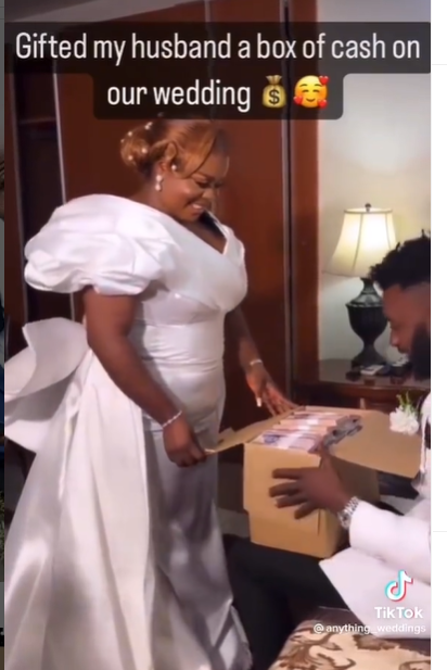 Bride gives her groom a box filled with cash on their wedding day (video)