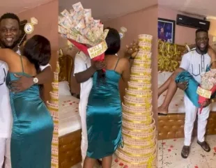 Man proposes to girlfriend with gigantic money cake of 5 and 10 naira notes (Photos)