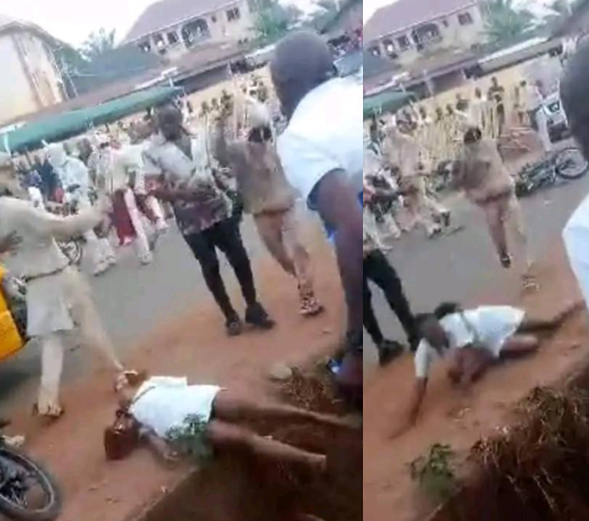 Anger Erupts as Masquerades Brutally Beat Female Nurse Until She Falls in a Gutter in Enugu (Video)